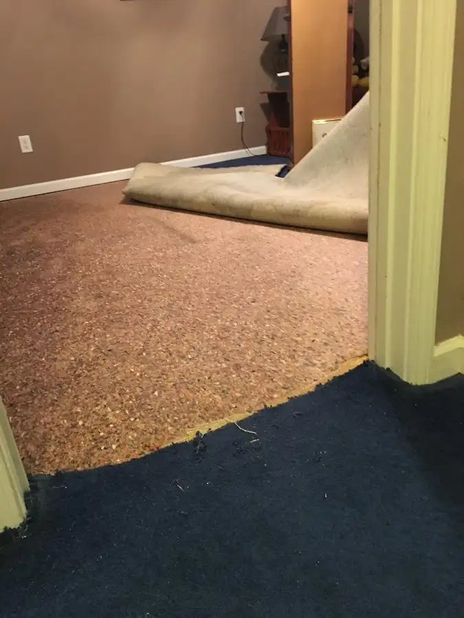Carpet pad removal revealing water damage during Water Mitigation Services in Lehighton